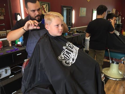 Mike cutting my son's hair. He did a great job.