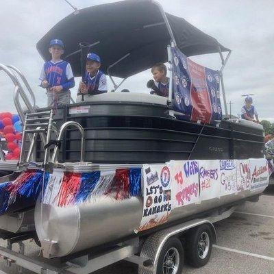 Parade in Alvin Texas. Little baseball leaguers in a Crest Pontoon boat from Action Boat Center.