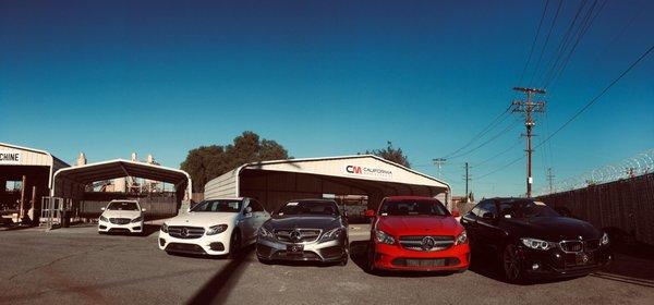 Repaired vehicles ready for delivery, work area In The back ground