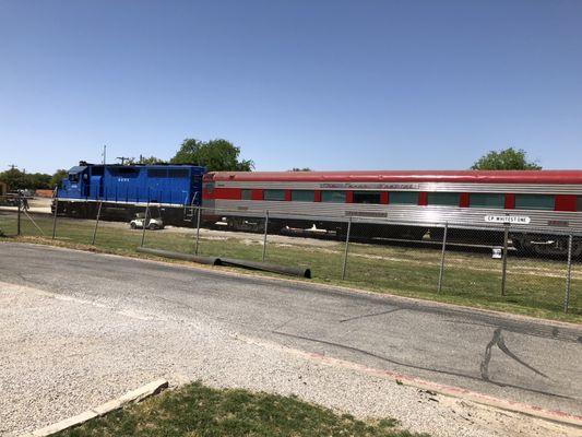 Neat passenger train sitting on the siding out back