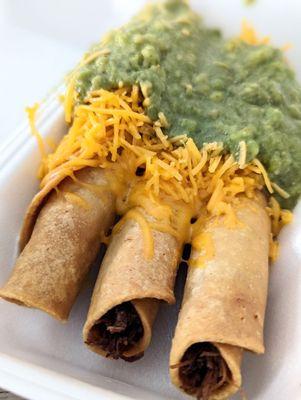 Rolled tacos with cheese and guacamole. Aka taquitos.