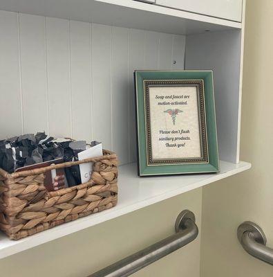 The bathroom is fully stocked for emergencies, and the faucet and soap dispenser are motion activated.