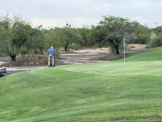 Ground crew literally dropping off tools next to the green and working. Not even caring about the golfers.