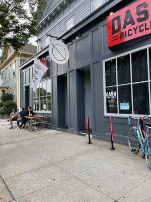 The entrance of the cafe right next to the bike shop entrance