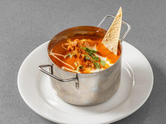 Chicken with the bone cooked in a creamy spicy tomato gravy. The way it is prepared in authentic Indian style.