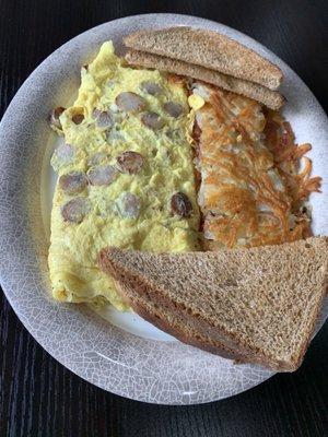 Sausage and egg omelet, hash browns with proper crispness, but off-putting flavor, and wheat toast.