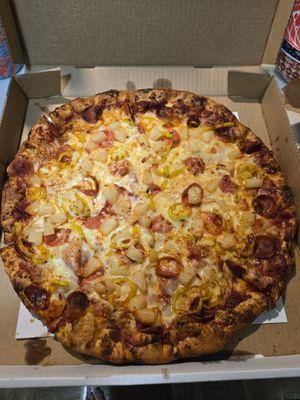 Large pizza with pepperoni, pineapple, and peppers.