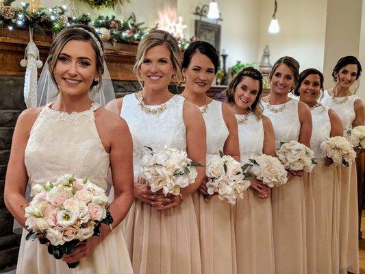 The bride and her attendants in front of the fireplace.