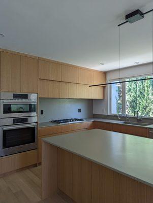 Japandi white oak kitchen with cement countertops