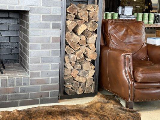 Animal skin rugs, wood ready to burn, comfortable sofa and chairs. A nice little reading nook area.