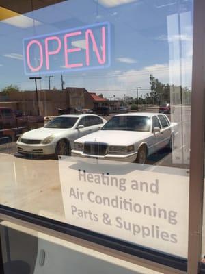 Seeing the OPEN sign lit on Saturday next to the sign "heating and air-conditioning parts and supplies" made me very happy.