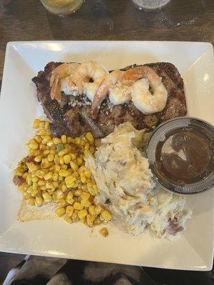 Steak special with mashed potatoes with side of gravy, seasoned corn and shrimp scampi