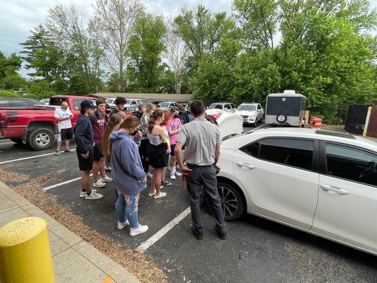 Hosting a group of high school students and teaching them how to put on the spare tire.