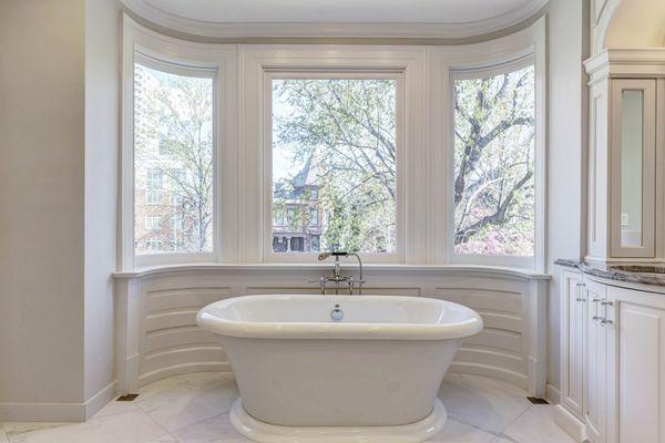 Fully renovated bow window were made to built and installed behind the free standing tub.