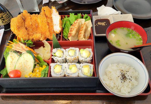 Pork Katsu Don Bento with pot stickers, California roll, salad, rice and miso soup.