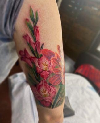 Newest tattoo, gladiolus 5Oct24 by Chris H. @chris_h_art_ink on IG.