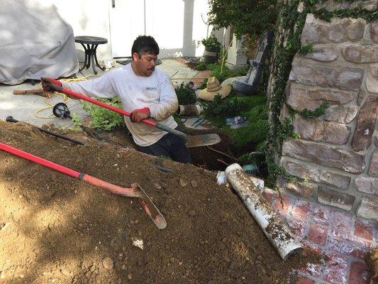 The crew dug under a wall and a concrete slab to make a repair.