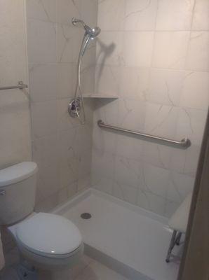 New tile shower with Moen grab bars & Freedom fold down bench