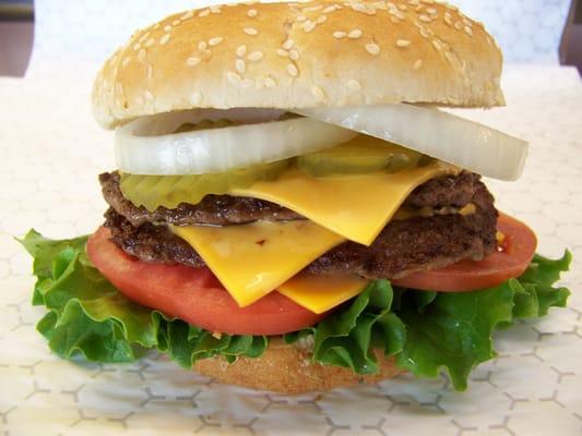 Mega Double comes with two 1/4 lb beef patties, three slices of  cheese, mayo, ketchup, lettuce, tomato, onion & pickle