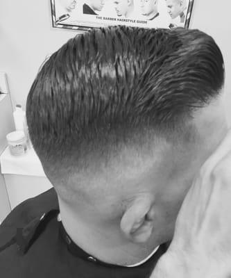 Mid skin fade with a comb over top