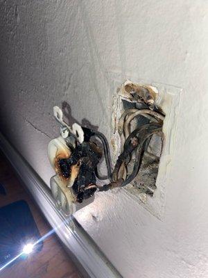 Inside the outlet, it's clear to see we need an electrical inspection.