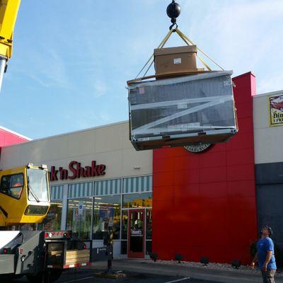 20 Ton crane hoisting new replacement RTU onto the roof of Steak-N-Shake.