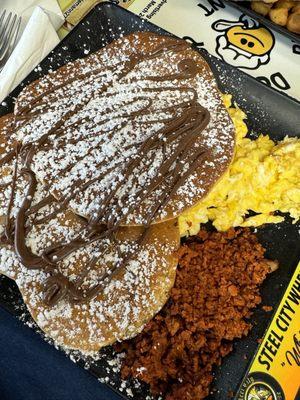 Delicious egg combo breakfast with veggie chorizo and Nutella hot cakes.