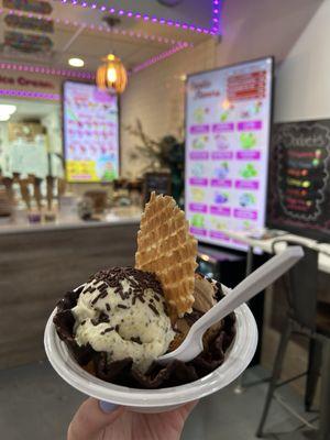 Pistachio flavor ice cream in a chocolate covered waffle bowl