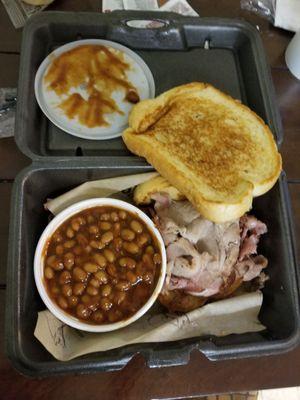 Sliced pork sandwich on garlic toast w/side of baked beans