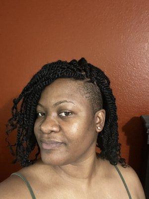 Springy Afro twist. Both sides of head shaved.