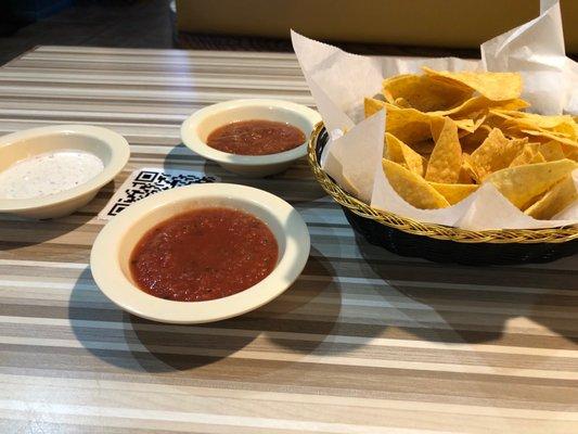 Complimentary chips with mild, spicy and spicy each sauce.