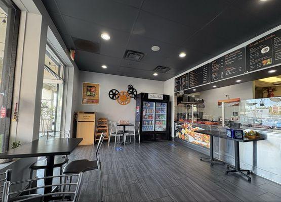 Restaurant interior, service counter, drink cooler, and tables