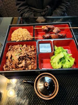 Mongolian barbecue, pork fried rice, steamed broccoli and teriyaki chicken skewers.