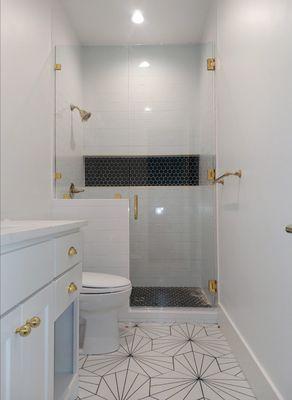 Frameless shower door, gold hardware