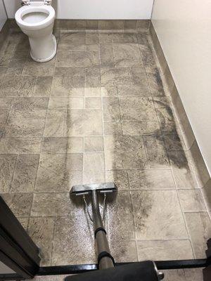 Power Scrub and Steam Clean Vinyl Restroom Floor.