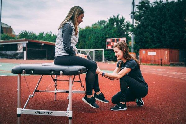 Dr. Heather evaluating a patient with knee pain after running long distances.