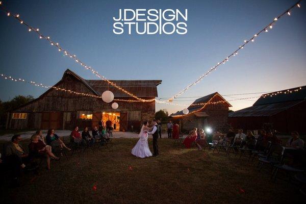 Bride and groom dance under the lights in the Barn Courtyard at the Civil War Ranch, MO.