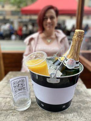 Bottomless mimosas come served with your own bottles and orange juice in a cute bucket! Pour your own!