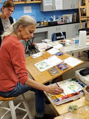 Alice O'Leary teaching a watercolor painting class in the drawing and painting studio.