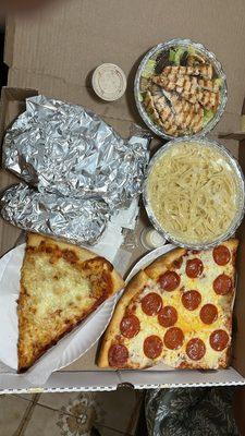 Grilled Chicken Caesar Salad, Garlic Knots, Fettuccine Alfredo and slices