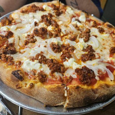 Chorizo, onions, and goat cheese pizza