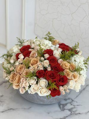 A mix of oranges & whites in a large round vase