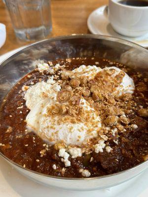 Lamb shakahuka breakfast with poached eggs and warm pita