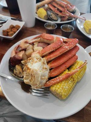 Seafood boil platter with snow crab legs.