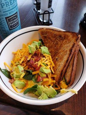 Bacon avocado egg breakfast bowl with vanilla creme coffee.