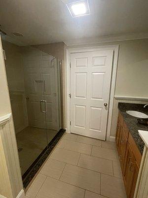 Walk in shower with rainfall shower head. Double sinks and makeup mirror under cabinet