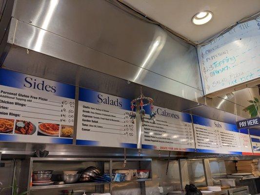 The menu board hanging over the counter. we love this place, our second visit this week.