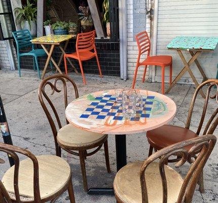 Outdoor sidewalk tables are chess tables.