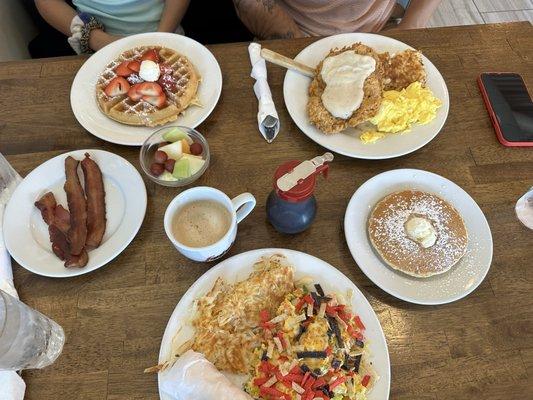 Migas, chicken fried steak and eggs, strawberry waffle