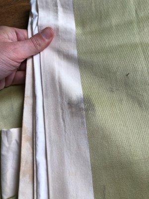 Dirt, stains, and grime still on linens after I took them home.